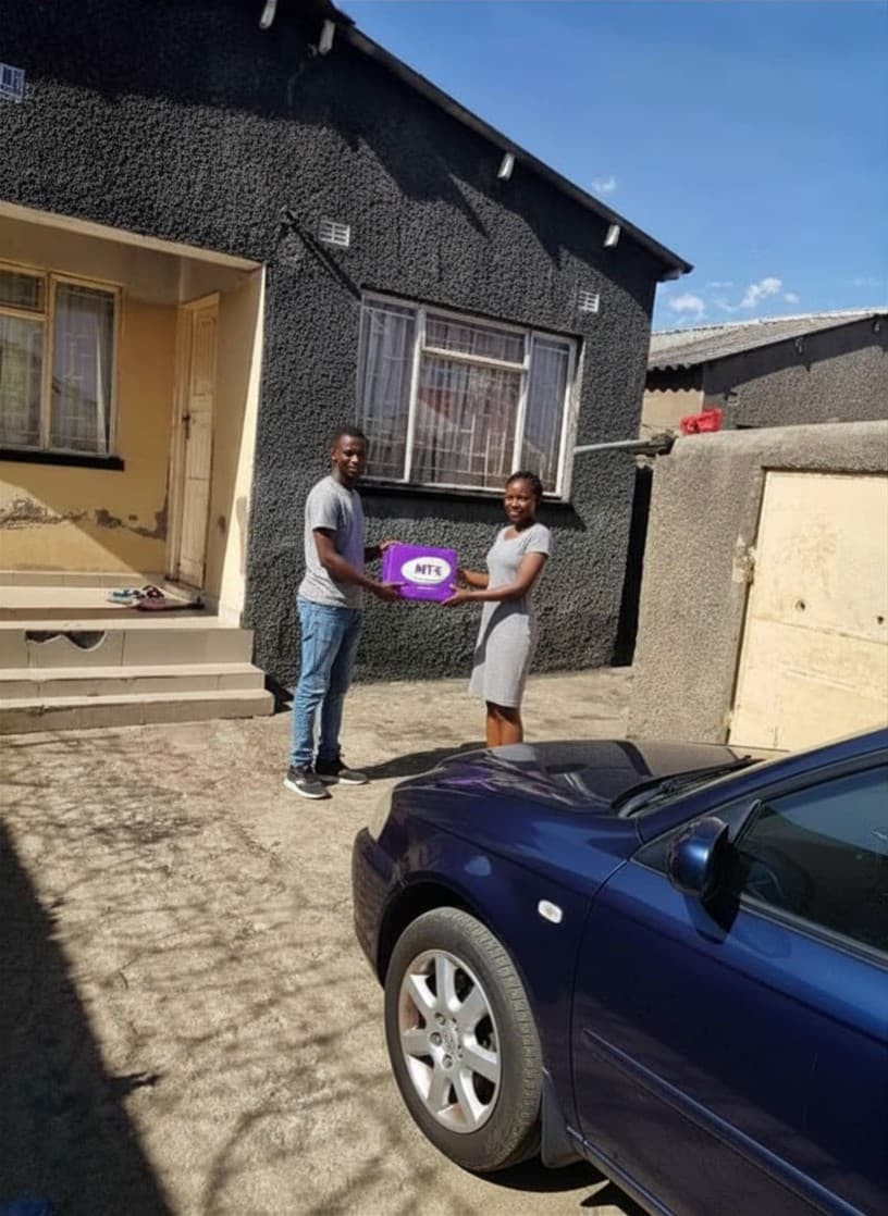 A MyTipKart courier delivering a parcel in Zimbabwe